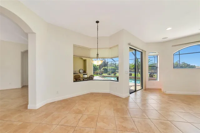 a kitchen with stainless steel appliances granite countertop a kitchen island a stove a sink a microwave and a refrigerator