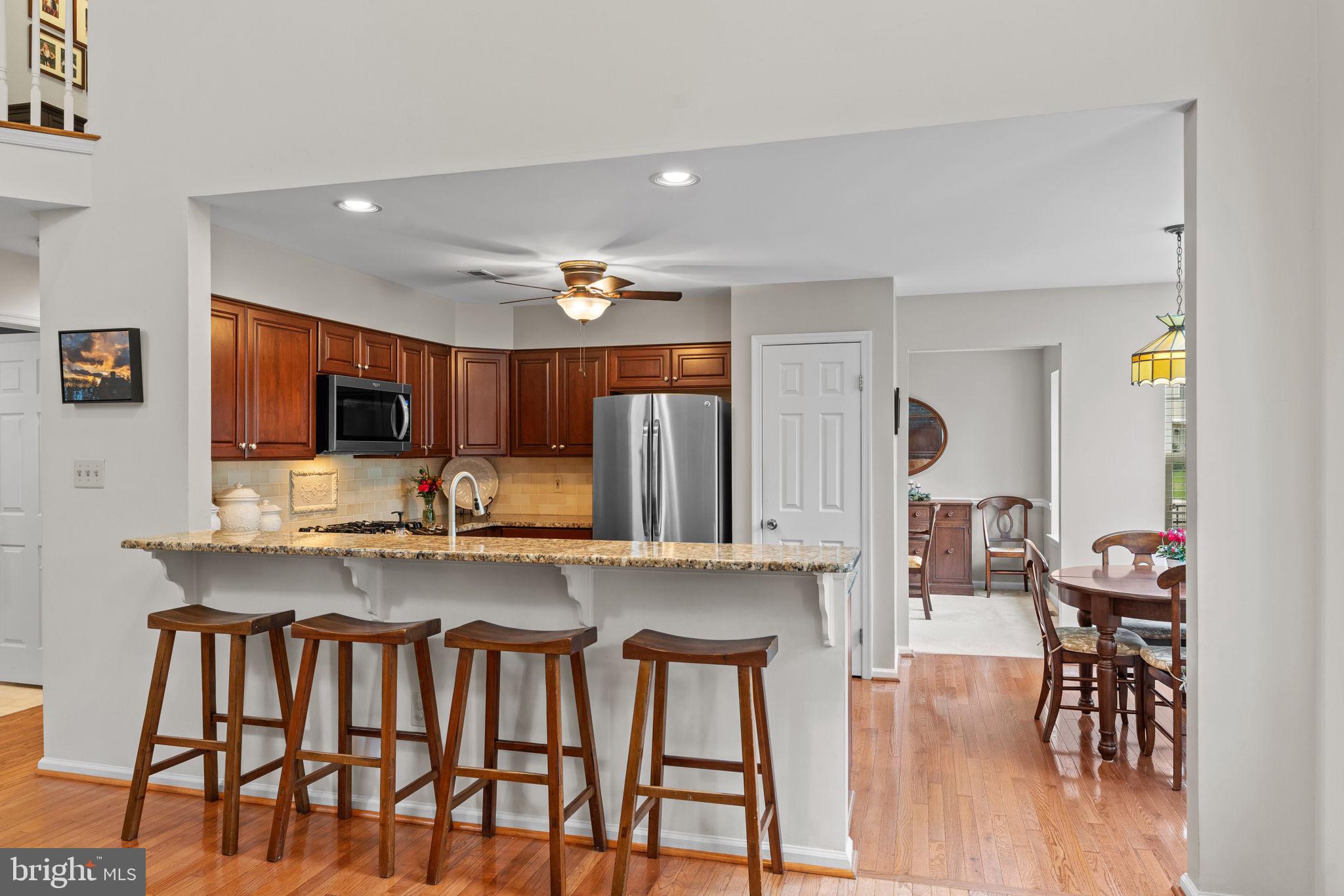 803 Red Coat Road Collegeville, PA 19426 - Photo 12 of 33 a kitchen with stainless steel appliances a kitchen island hardwood floor and a sink