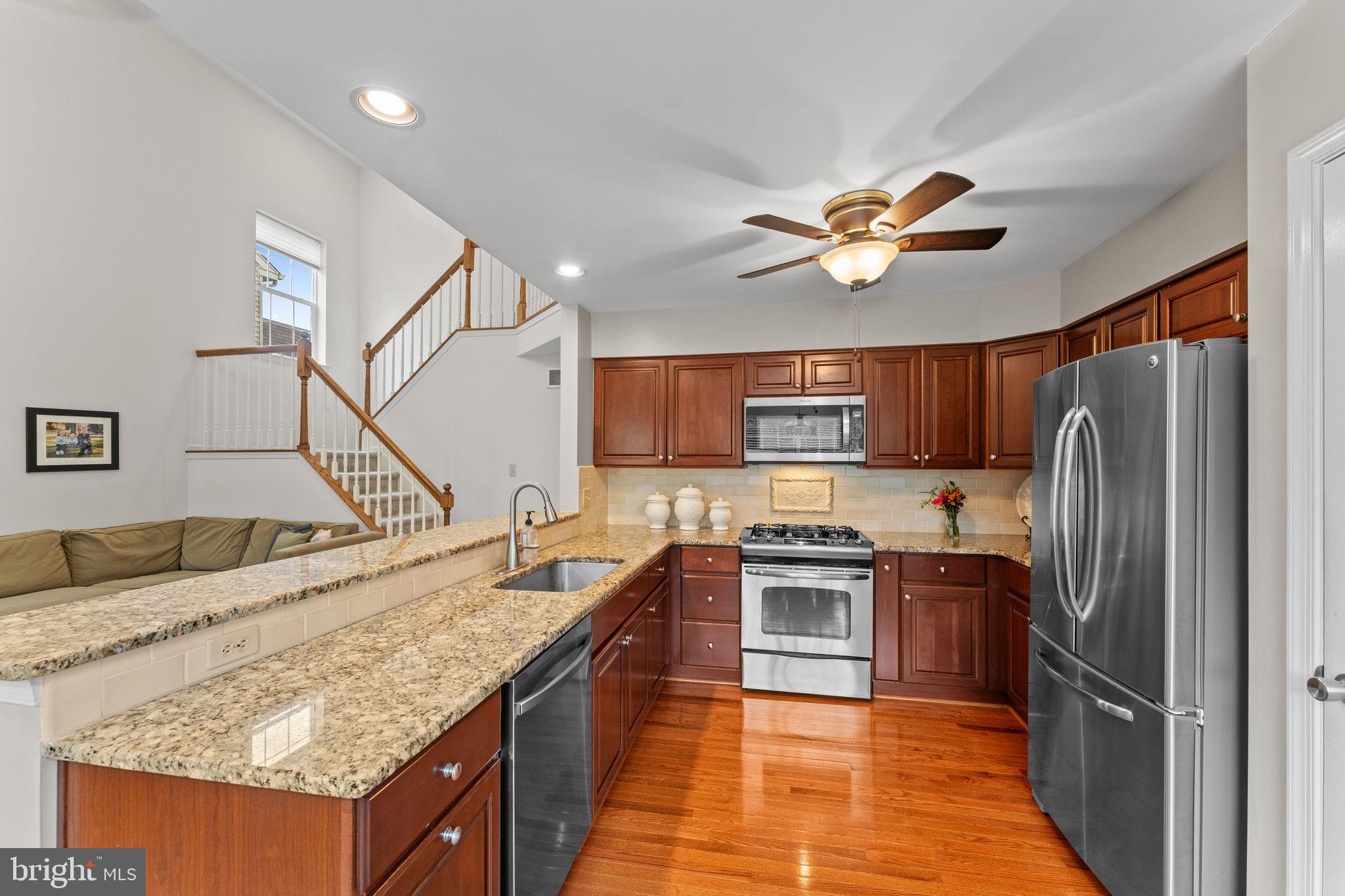 803 Red Coat Road Collegeville, PA 19426 - Photo 13 of 33 a kitchen with stainless steel appliances granite countertop a refrigerator a stove and a sink