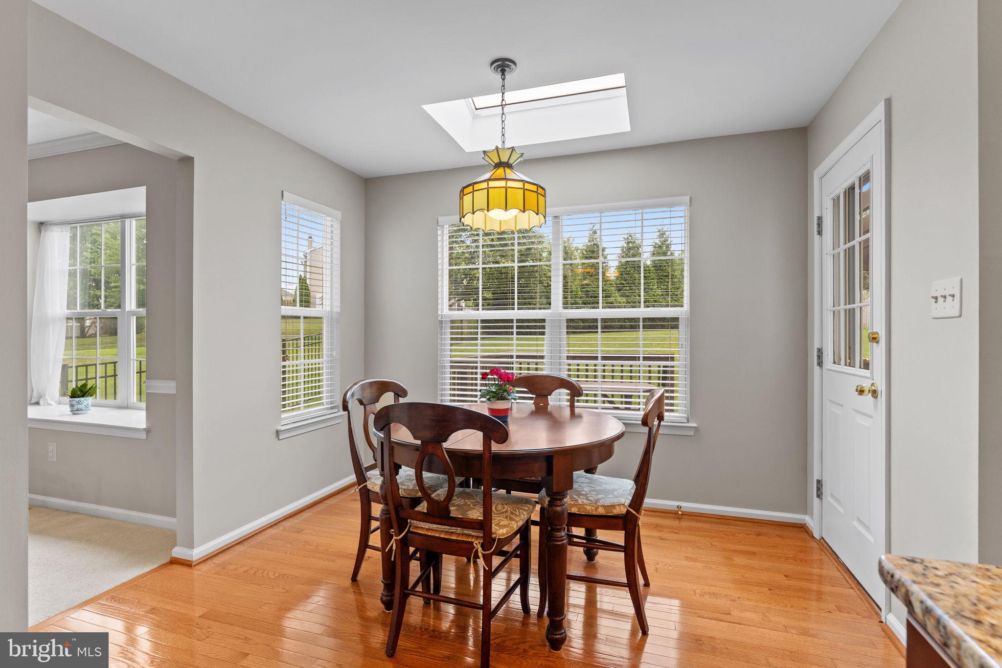 803 Red Coat Road Collegeville, PA 19426 - Photo 15 of 33 a dining room with furniture a chandelier and wooden floor
