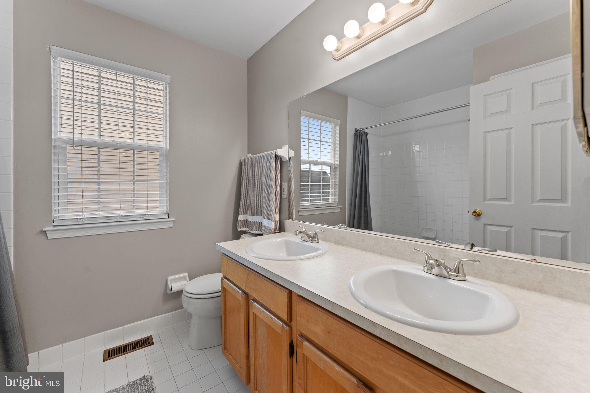 803 Red Coat Road Collegeville, PA 19426 - Photo 25 of 33 a bathroom with a granite countertop sink and a mirror