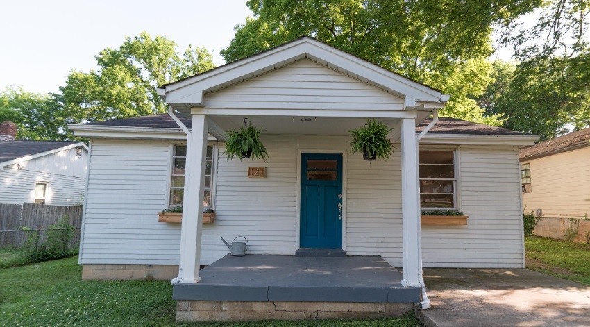 a front view of a house with a garden