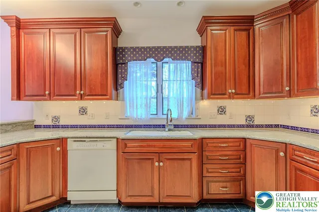 a kitchen with stainless steel appliances granite countertop wooden cabinets a sink and dishwasher