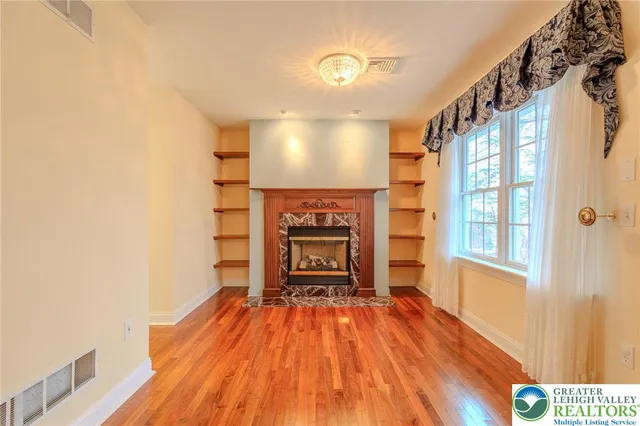 a large bathroom with a granite countertop double vanity sink a mirror and a bathtub