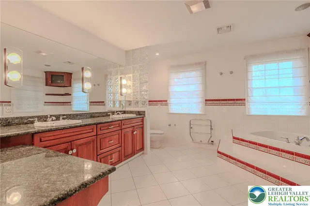 a bathroom with a tub and a shower