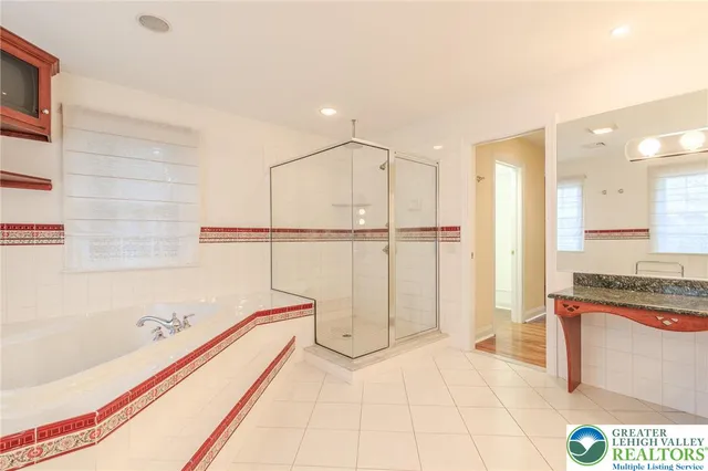 a bathroom with a bathtub and a shower