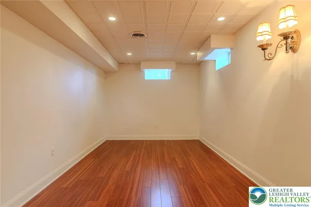 a view of a room with wooden floor