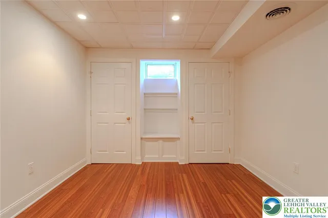 a view of a room with wooden floor and brick walls