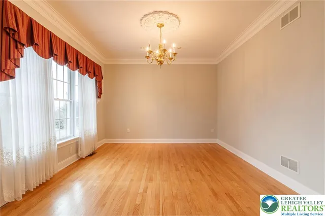 a view of a house with a tree in the background