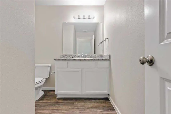 a bathroom with a sink a toilet and mirror