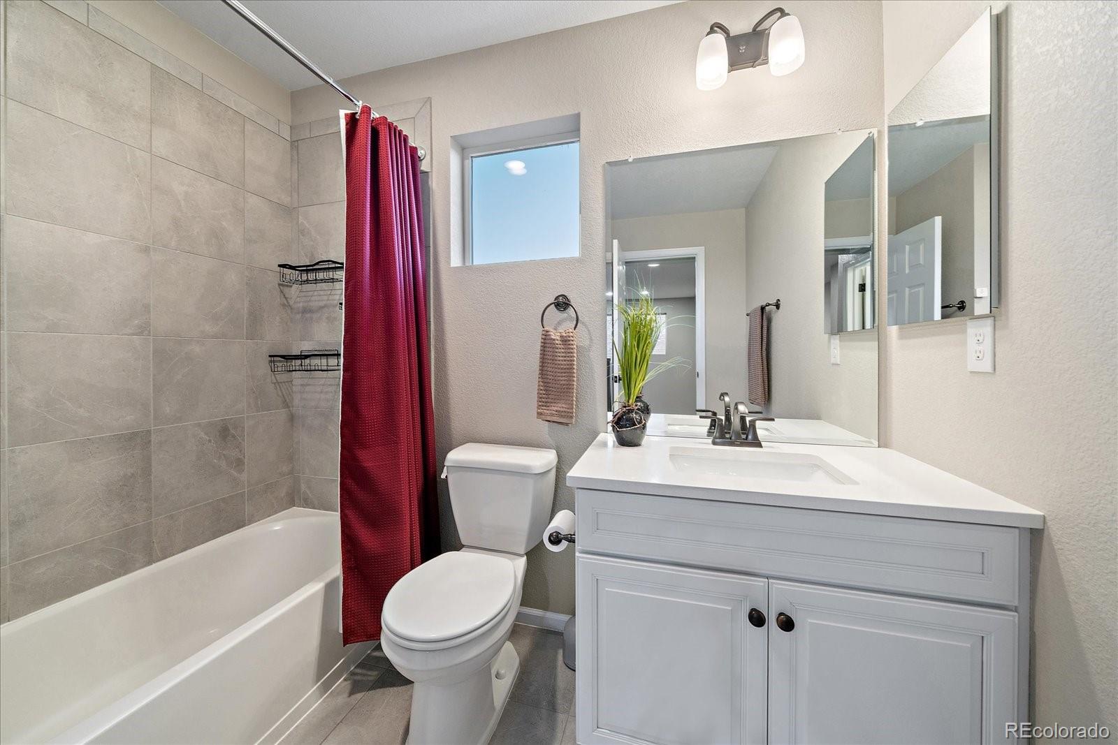 9382 Noble Way Arvada, CO 80007 - Photo 18 of 42 a bathroom with a sink toilet vanity and shower