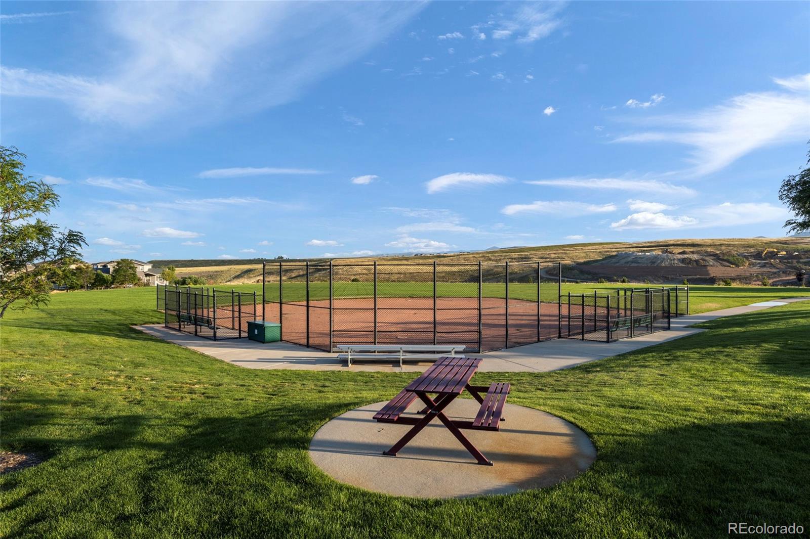 9382 Noble Way Arvada, CO 80007 - Photo 39 of 42 a view of a swimming pool with a garden