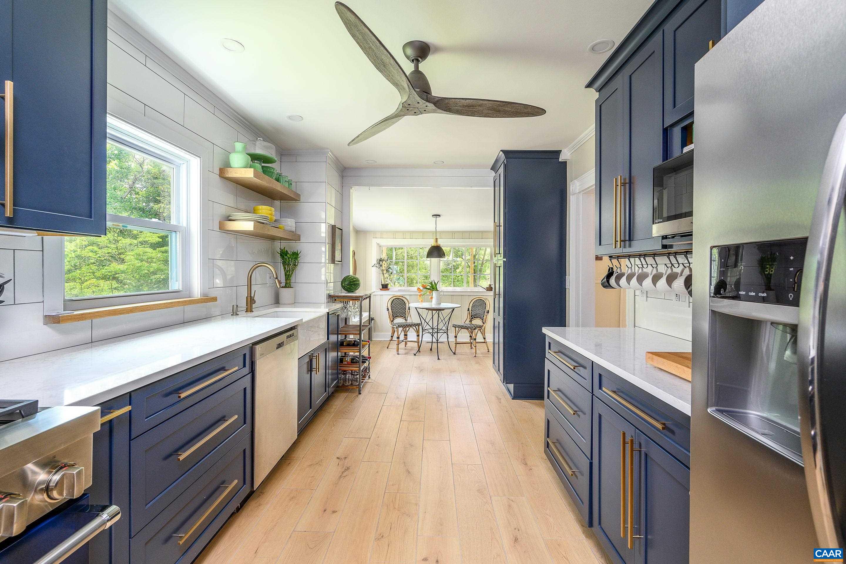 699 Ivy Depot Road Charlottesville, VA 22903 - Photo 11 of 55 a kitchen with stainless steel appliances granite countertop a refrigerator a sink dishwasher a stove and white countertops with wooden floor