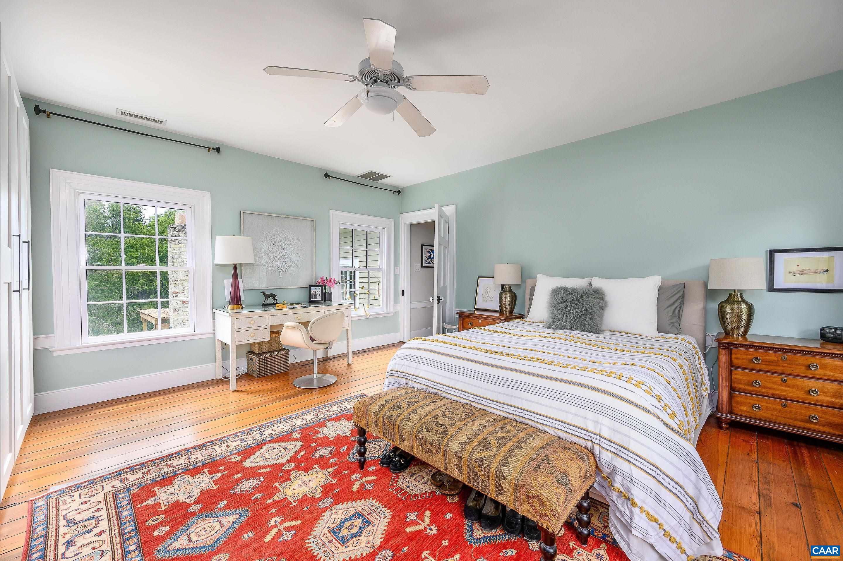 699 Ivy Depot Road Charlottesville, VA 22903 - Photo 21 of 55 a spacious bedroom with a bed a table and chair