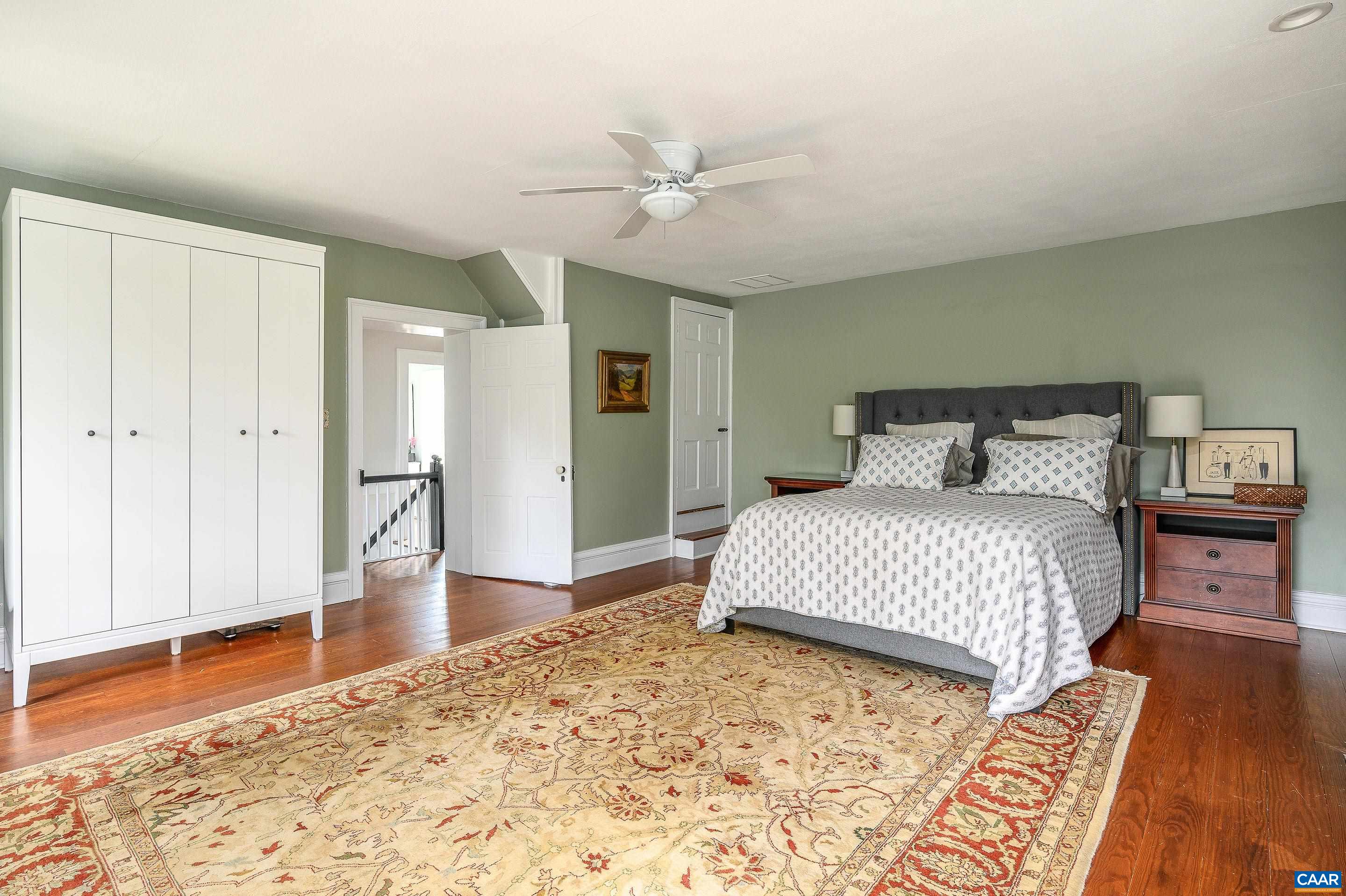 699 Ivy Depot Road Charlottesville, VA 22903 - Photo 23 of 55 a bedroom with a bed and wooden floor