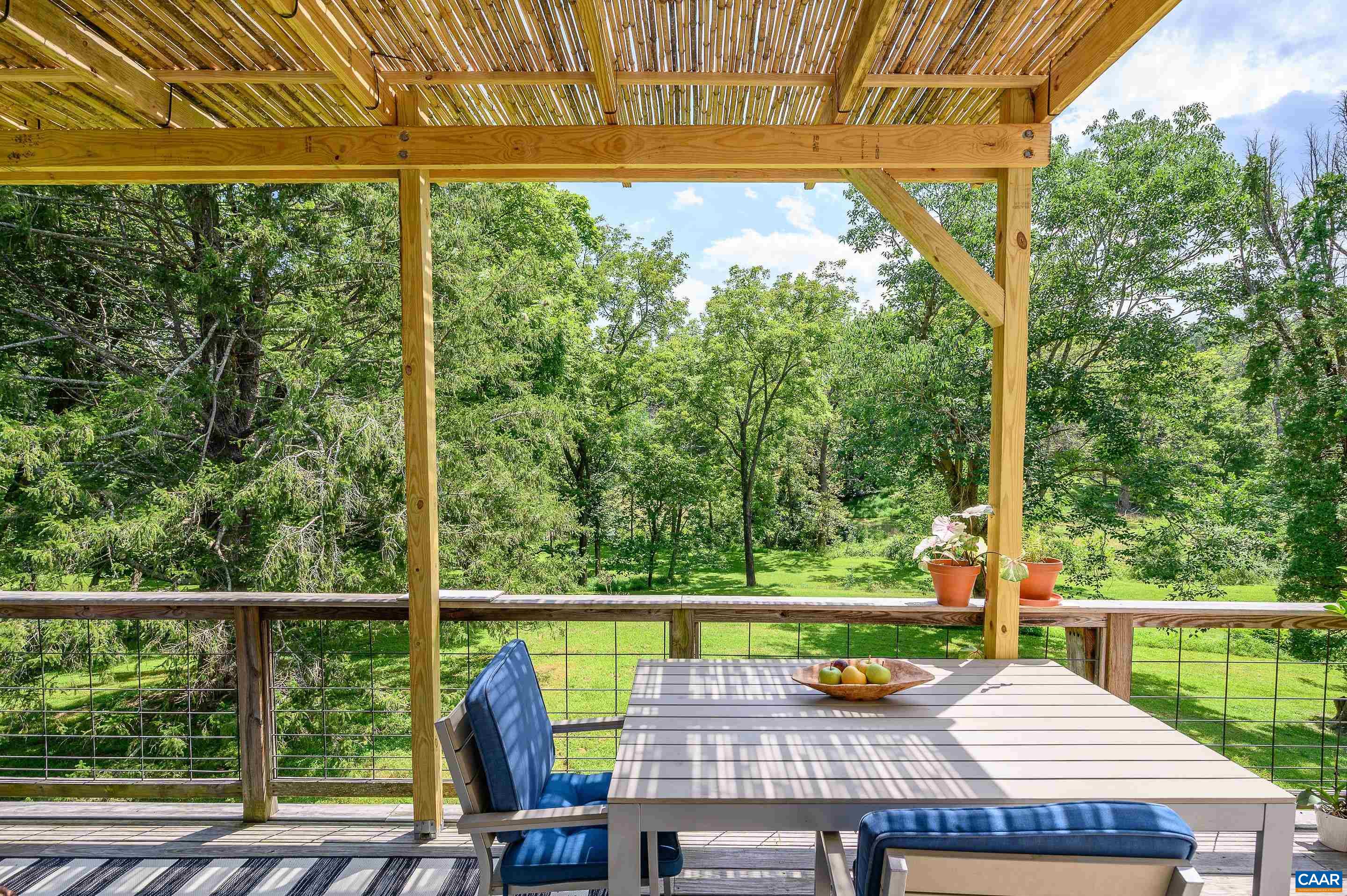 699 Ivy Depot Road Charlottesville, VA 22903 - Photo 33 of 55 a view of a chairs and table in patio with a yard