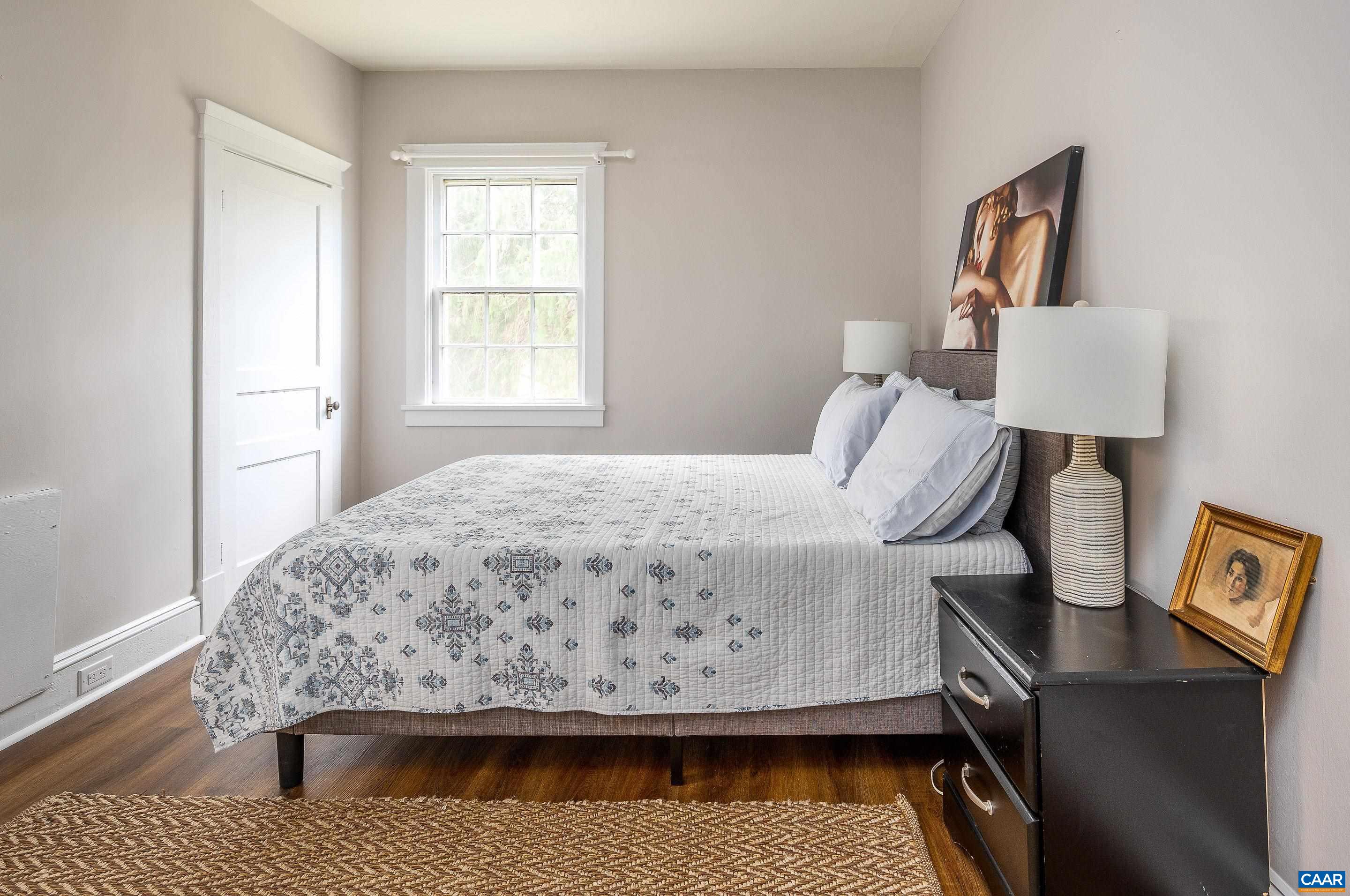 699 Ivy Depot Road Charlottesville, VA 22903 - Photo 44 of 55 a bed sitting in a bedroom next to a window