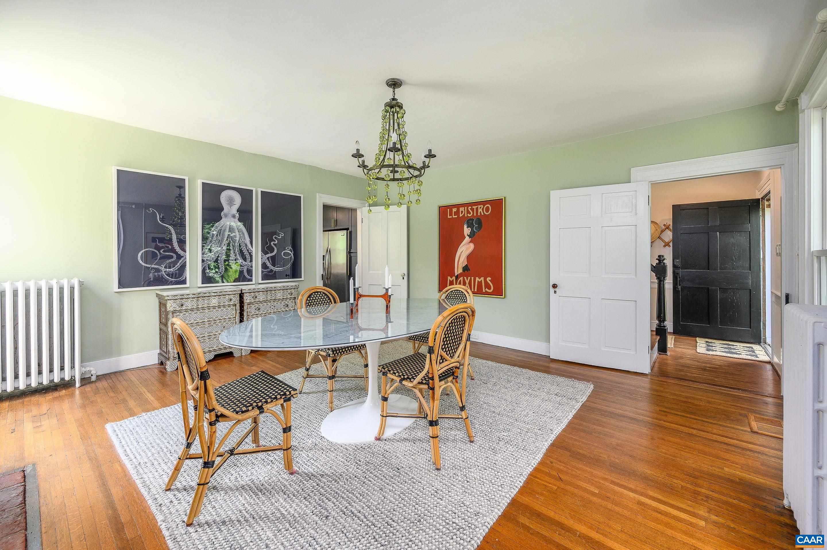 699 Ivy Depot Road Charlottesville, VA 22903 - Photo 9 of 55 a dining room with wooden floor a chandelier a wooden table and chairs