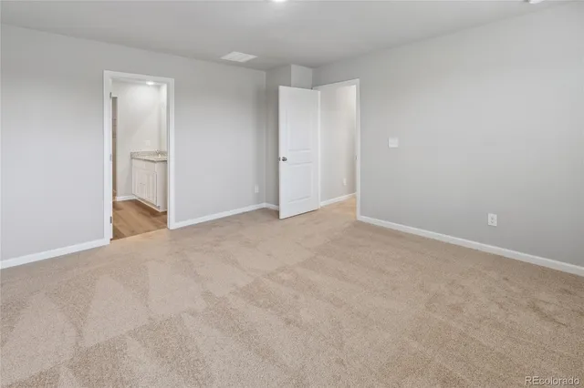 a view of an empty room and closet area