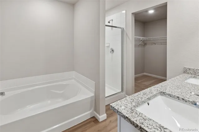 a bathroom with a granite countertop sink and shower