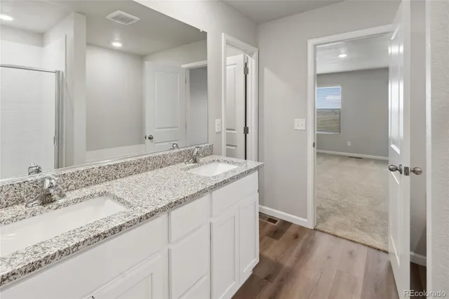 a bathroom with a granite countertop sink and a mirror