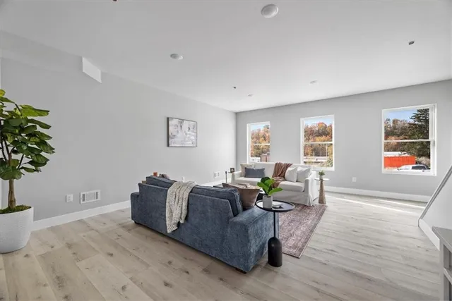 a living room with furniture and flowers
