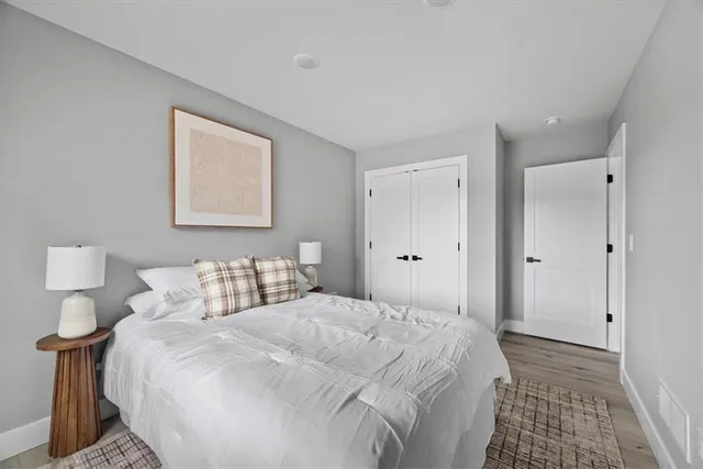 a bedroom with a bed and a night stand