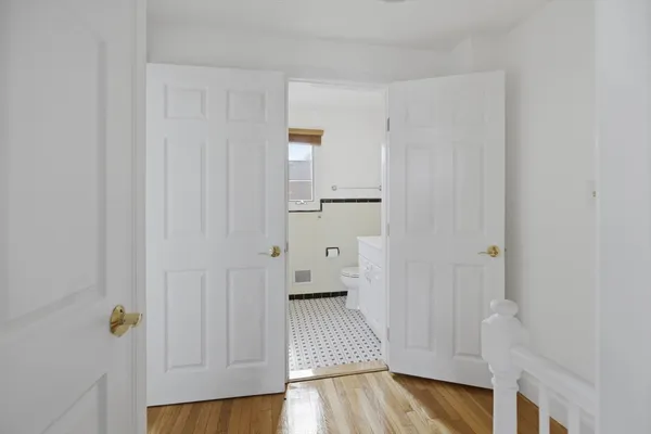 a view of a bathroom with wooden floor