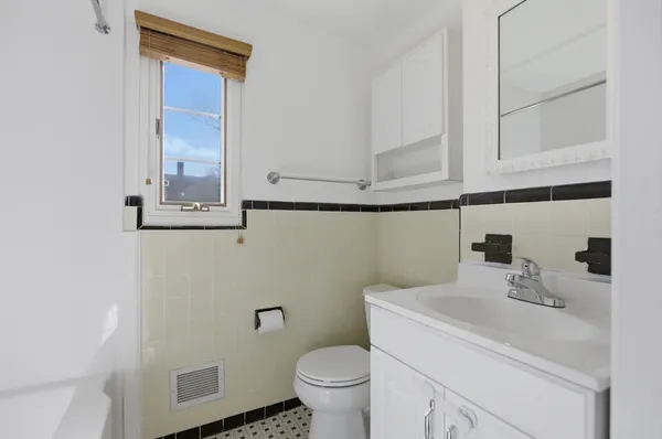 a bathroom with a sink a toilet and mirror