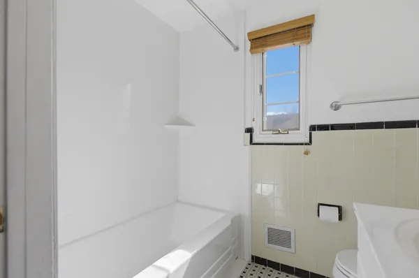 a bathroom with a bathtub and toilet