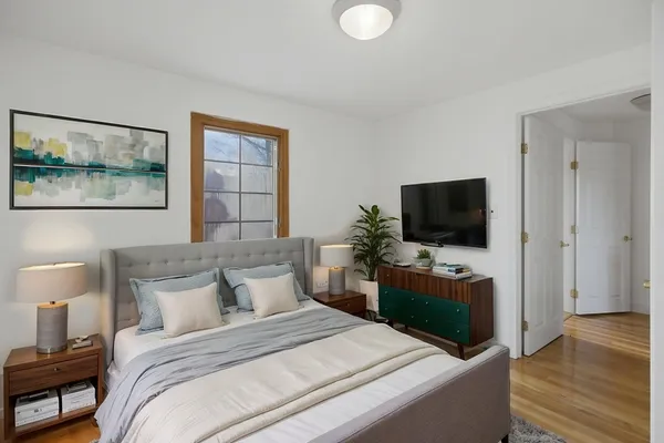 a bedroom with a bed and a television