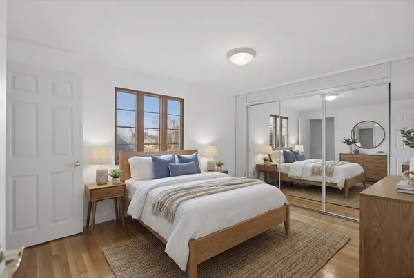 a bedroom with a bed and wooden floor