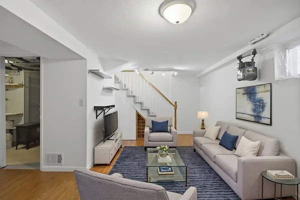 a living room with furniture and a painting