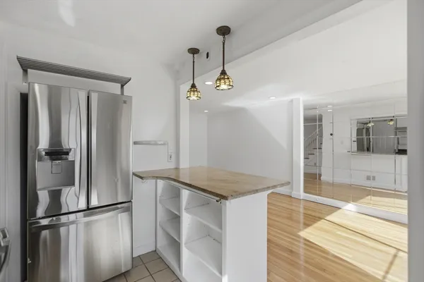 a kitchen with stainless steel appliances granite countertop a refrigerator and a sink