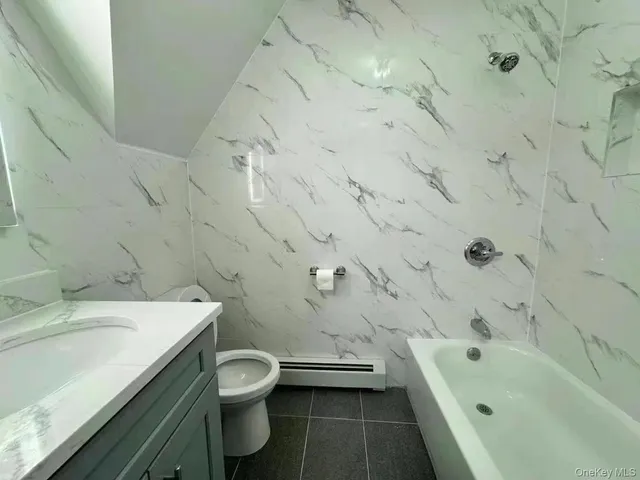 a bathroom with a sink a toilet and bathtub