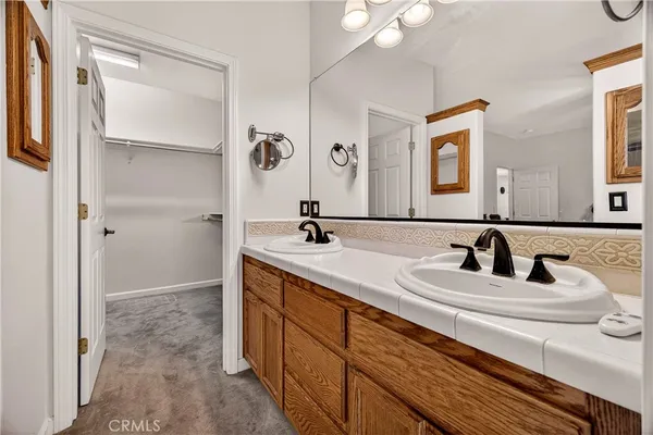 a bedroom with bed and a mirror