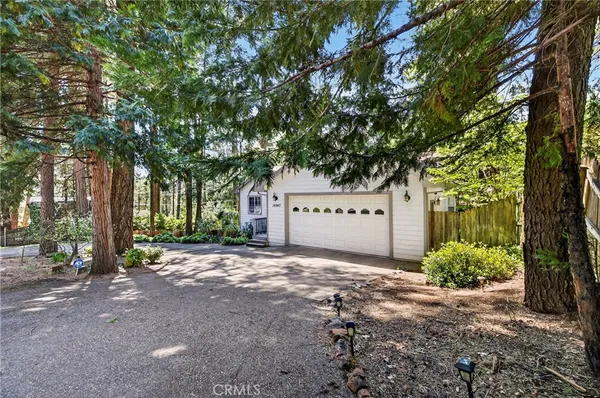 a view of a house with a tree in the background