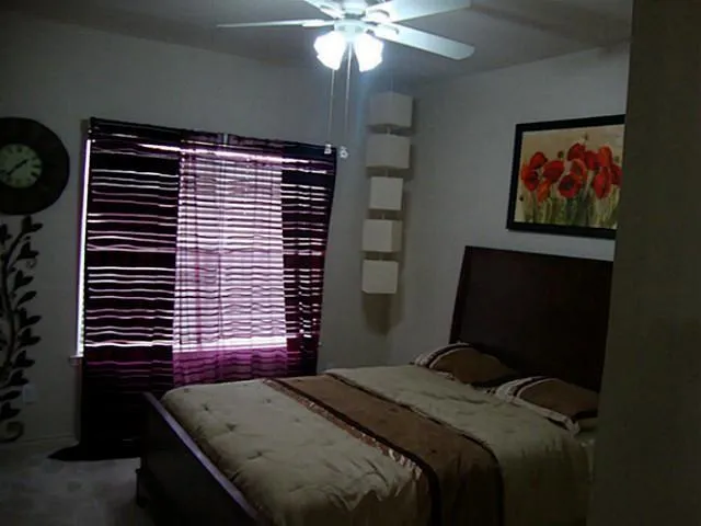 a bedroom with a bed and a window