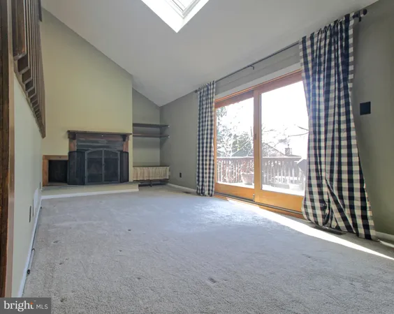 a view of empty room with a fireplace