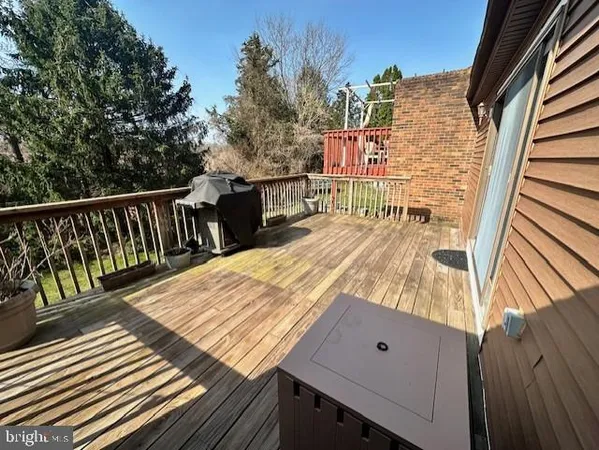 a view of balcony with wooden floor and seating space