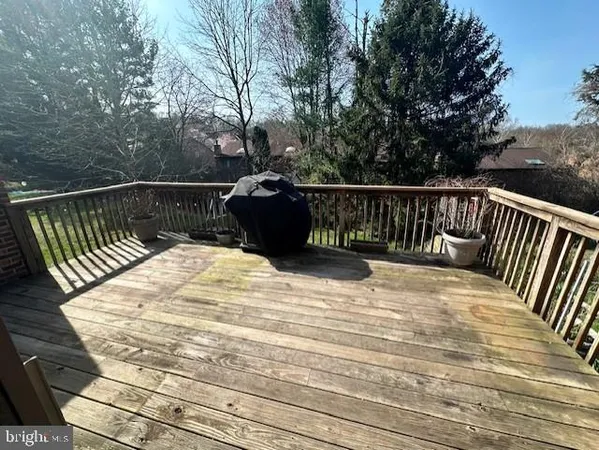 a view of balcony with wooden floor and fence