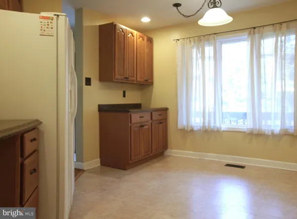 a view of a kitchen with dishwasher and a refrigerator