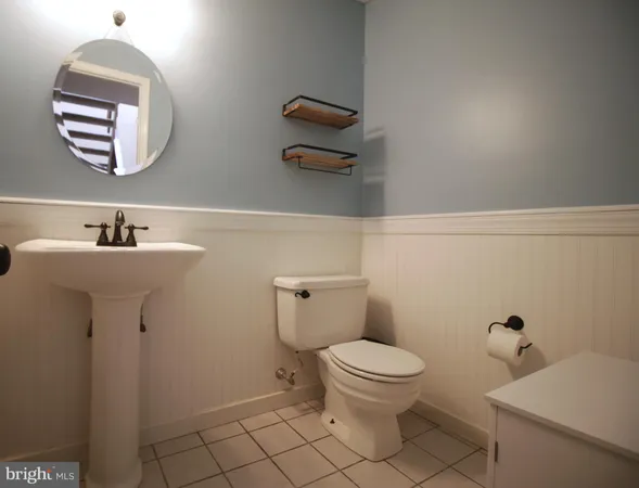 a bathroom with a sink mirror and toilet