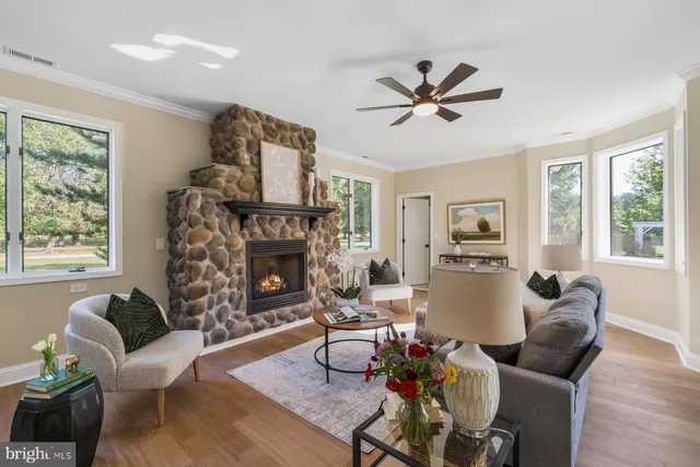 a living room with furniture a fireplace and a window