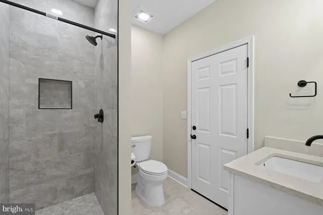 a bathroom with a toilet a sink and shower