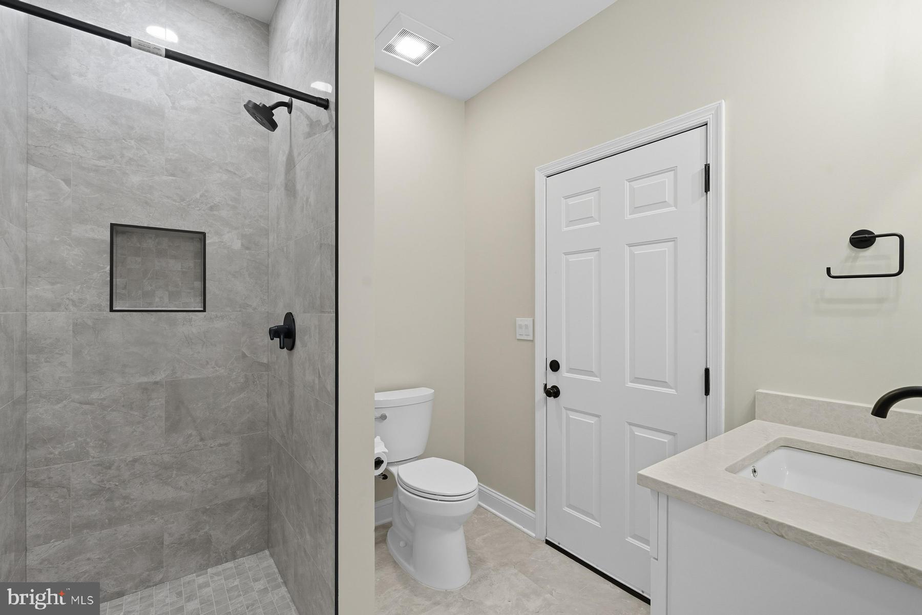 9171 Deepwater Point Road St. Michaels, MD 21663 - Photo 14 of 40 a bathroom with a toilet a sink and shower