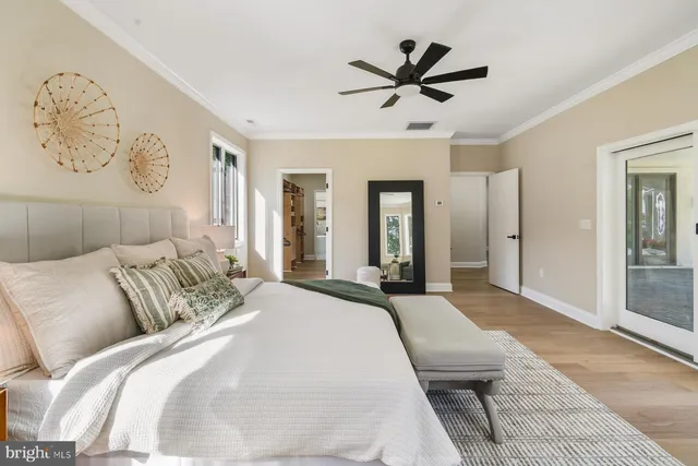 a spacious bedroom with a large bed and a chandelier