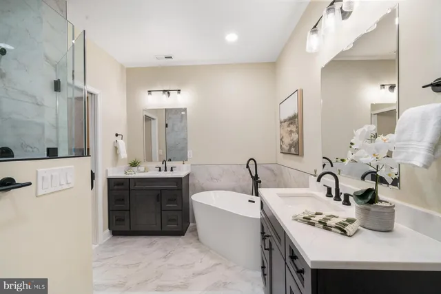 a bathroom with a sink double vanity and a mirror