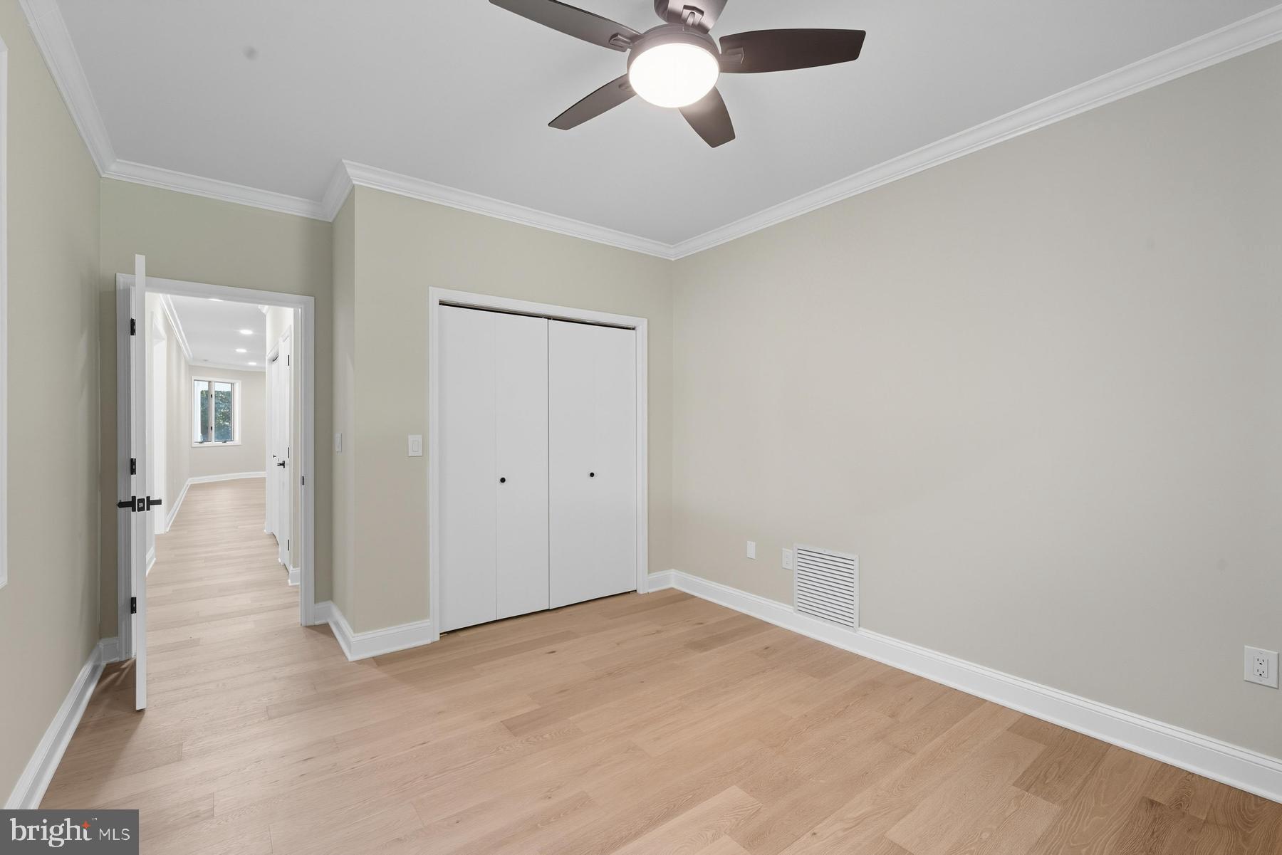 9171 Deepwater Point Road St. Michaels, MD 21663 - Photo 21 of 40 an empty room with a ceiling fan and carpet