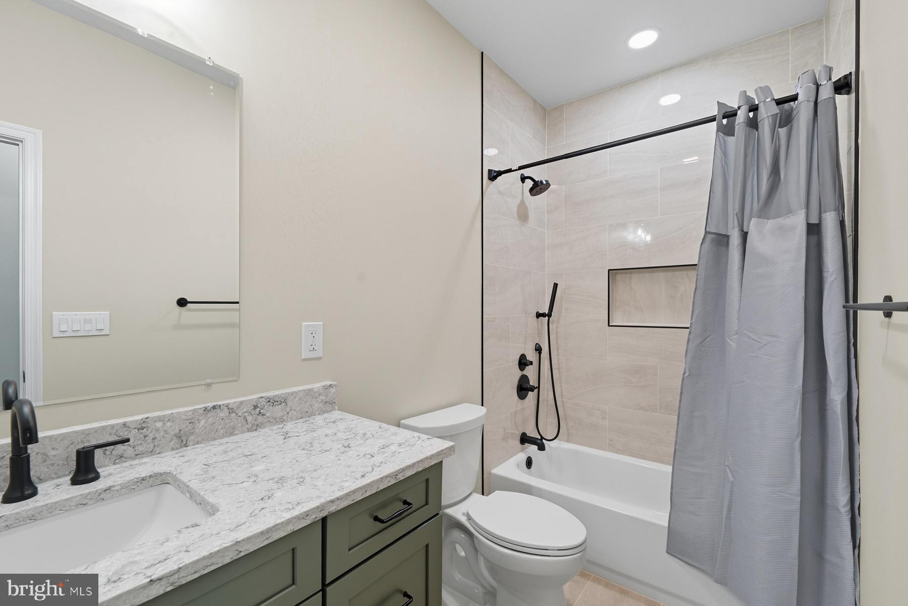 9171 Deepwater Point Road St. Michaels, MD 21663 - Photo 23 of 40 a bathroom with a granite countertop sink toilet and shower